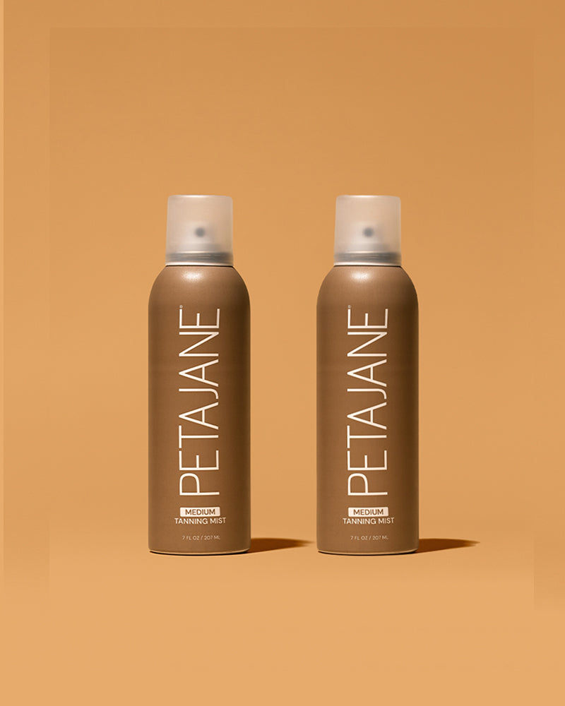 Two bottles of Peta Jane tanning mist on a brown background