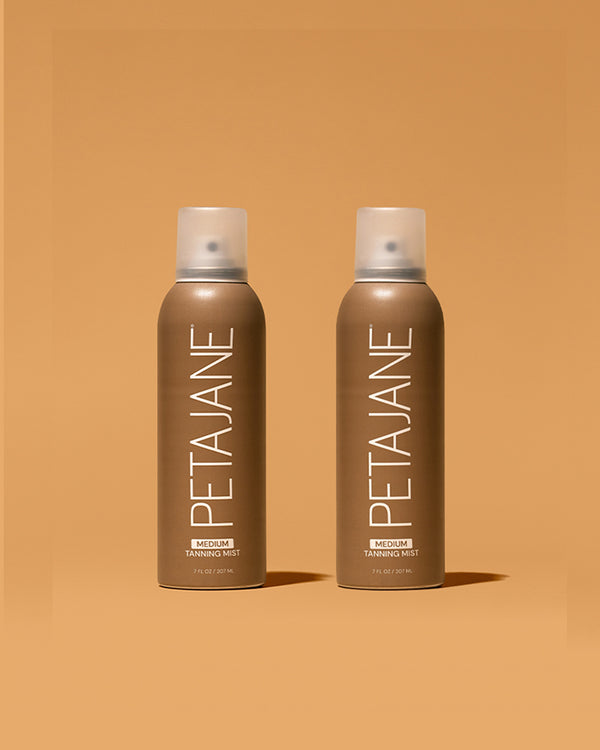 Two bottles of Peta Jane tanning mist on a brown background