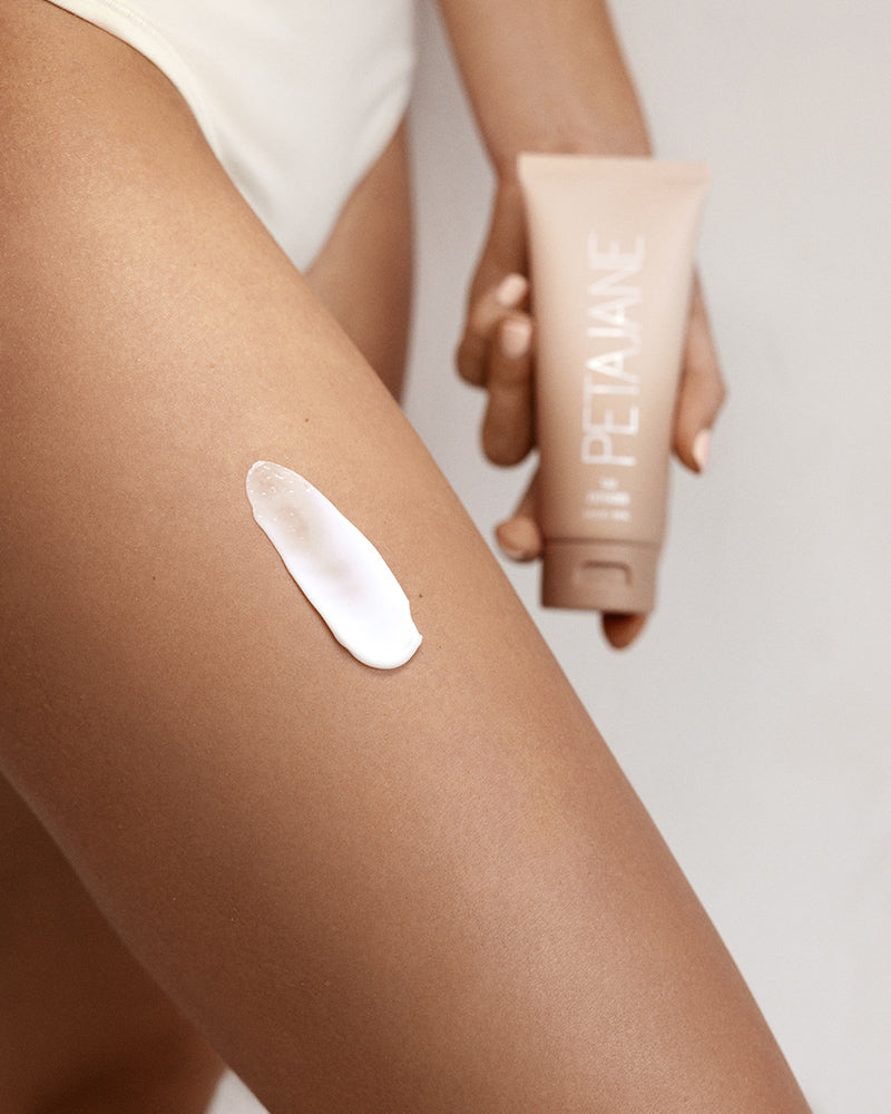 tan extender moisturizing lotion on a tan leg